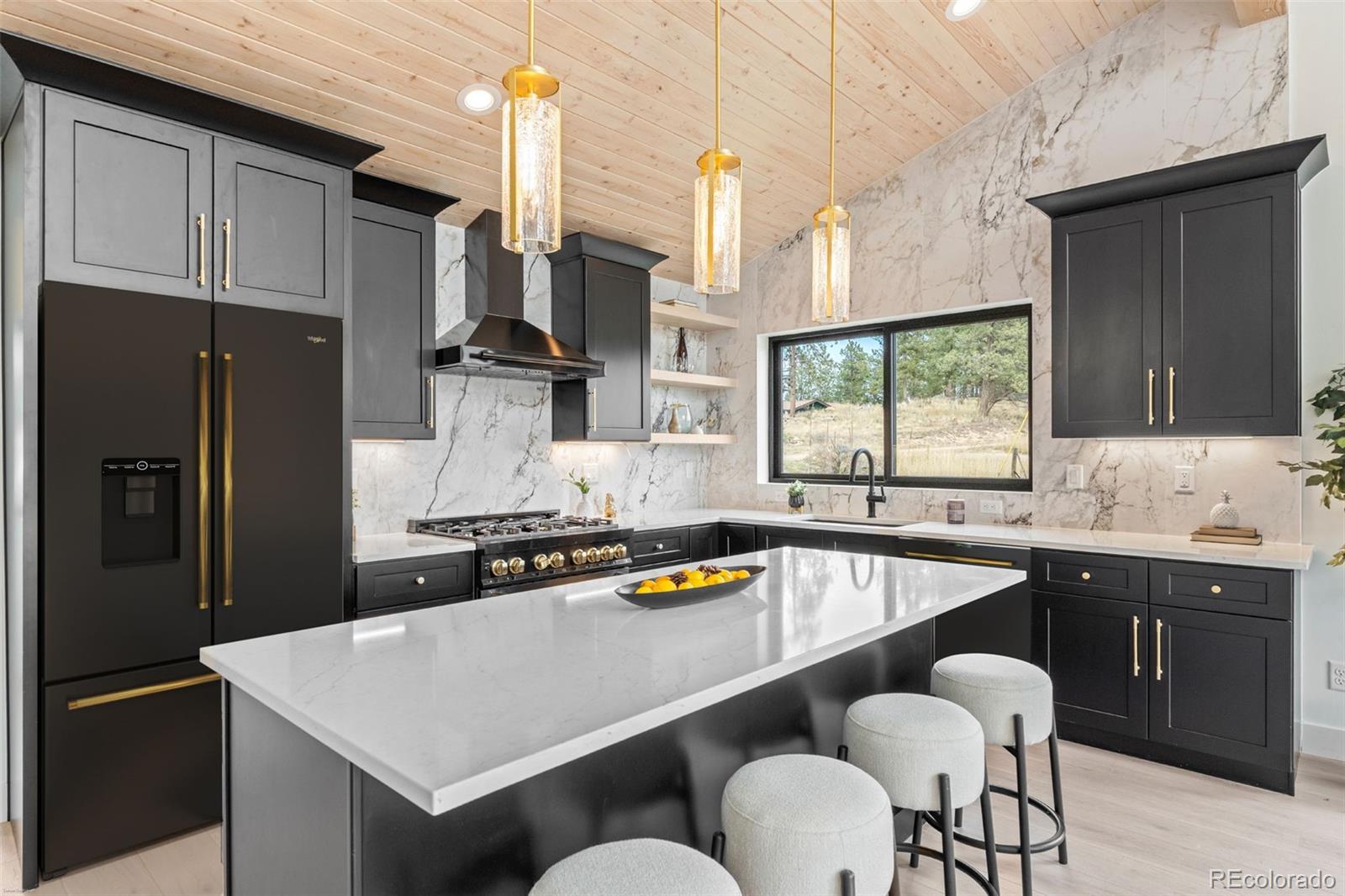 542 Conifer Drive Bailey, CO 80421 - Photo 21 of 47 a kitchen with stainless steel appliances granite countertop a sink stove and refrigerator