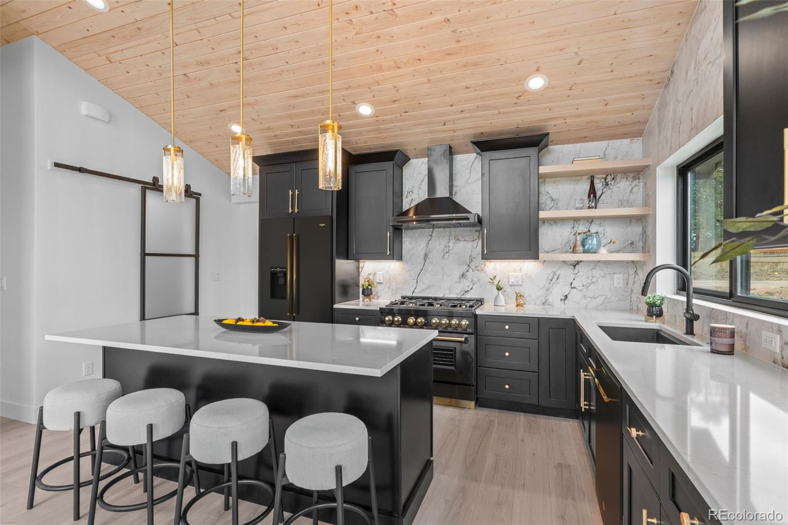 542 Conifer Drive Bailey, CO 80421 - Photo 23 of 47 a kitchen with granite countertop a sink stainless steel appliances and cabinets