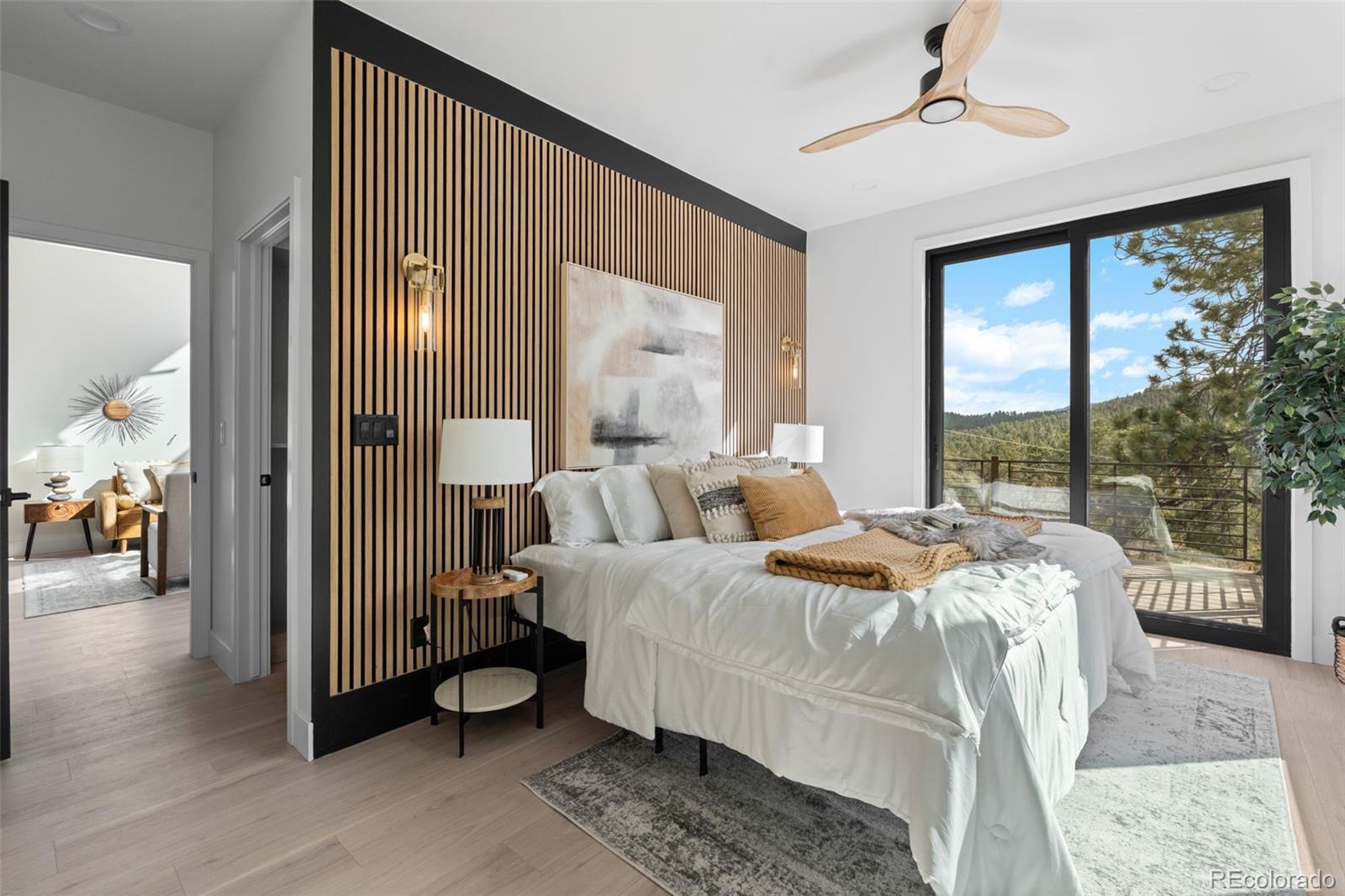 542 Conifer Drive Bailey, CO 80421 - Photo 25 of 47 a bed room with a bed and a large window