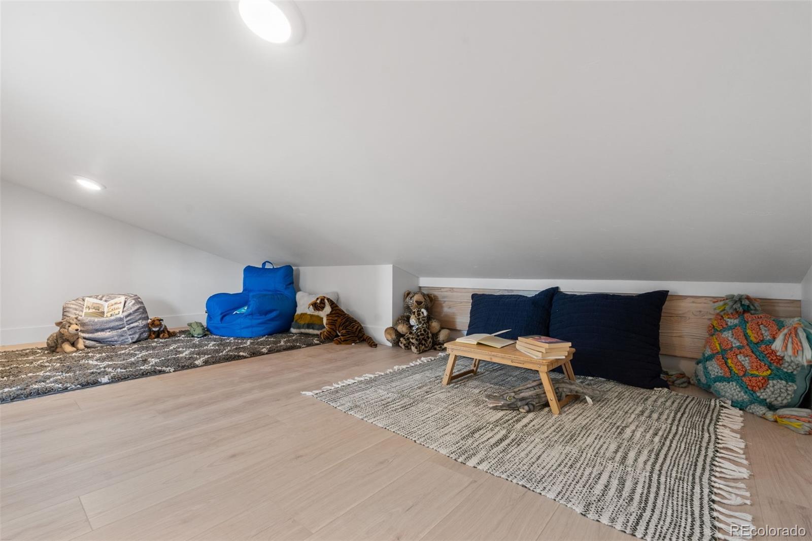 542 Conifer Drive Bailey, CO 80421 - Photo 36 of 47 a bedroom with a bed and wooden floor