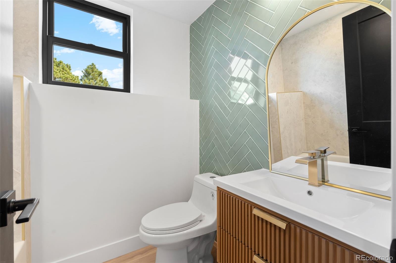 542 Conifer Drive Bailey, CO 80421 - Photo 44 of 47 a bathroom with a sink and a mirror
