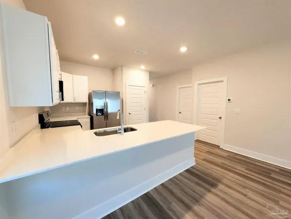 a view of kitchen with wooden floor