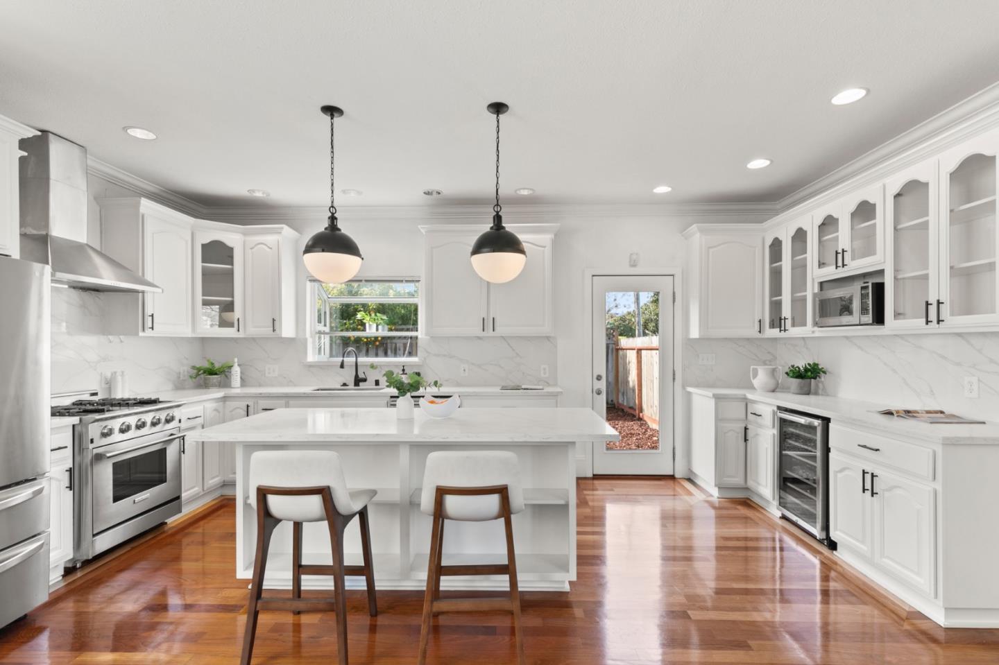 1095 Wright Avenue Mountain View, CA 94043 - Photo 8 of 29 a kitchen with stainless steel appliances granite countertop a stove top oven a sink a dining table and chairs with wooden floor