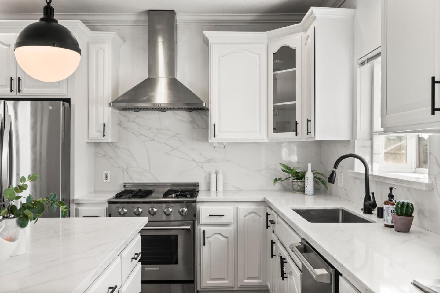 1095 Wright Avenue Mountain View, CA 94043 - Photo 9 of 29 a kitchen with stainless steel appliances a white cabinets wooden floor and a sink