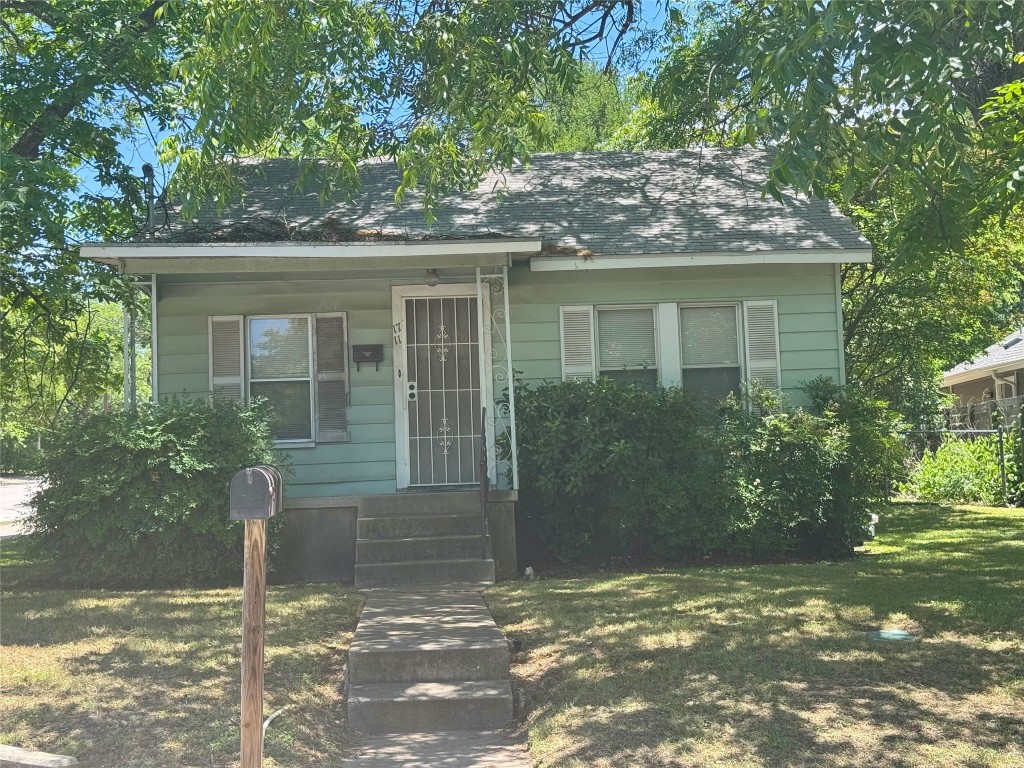 front view of a house with a tree