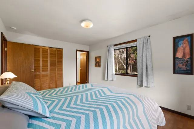 a bedroom with a bed and a tv