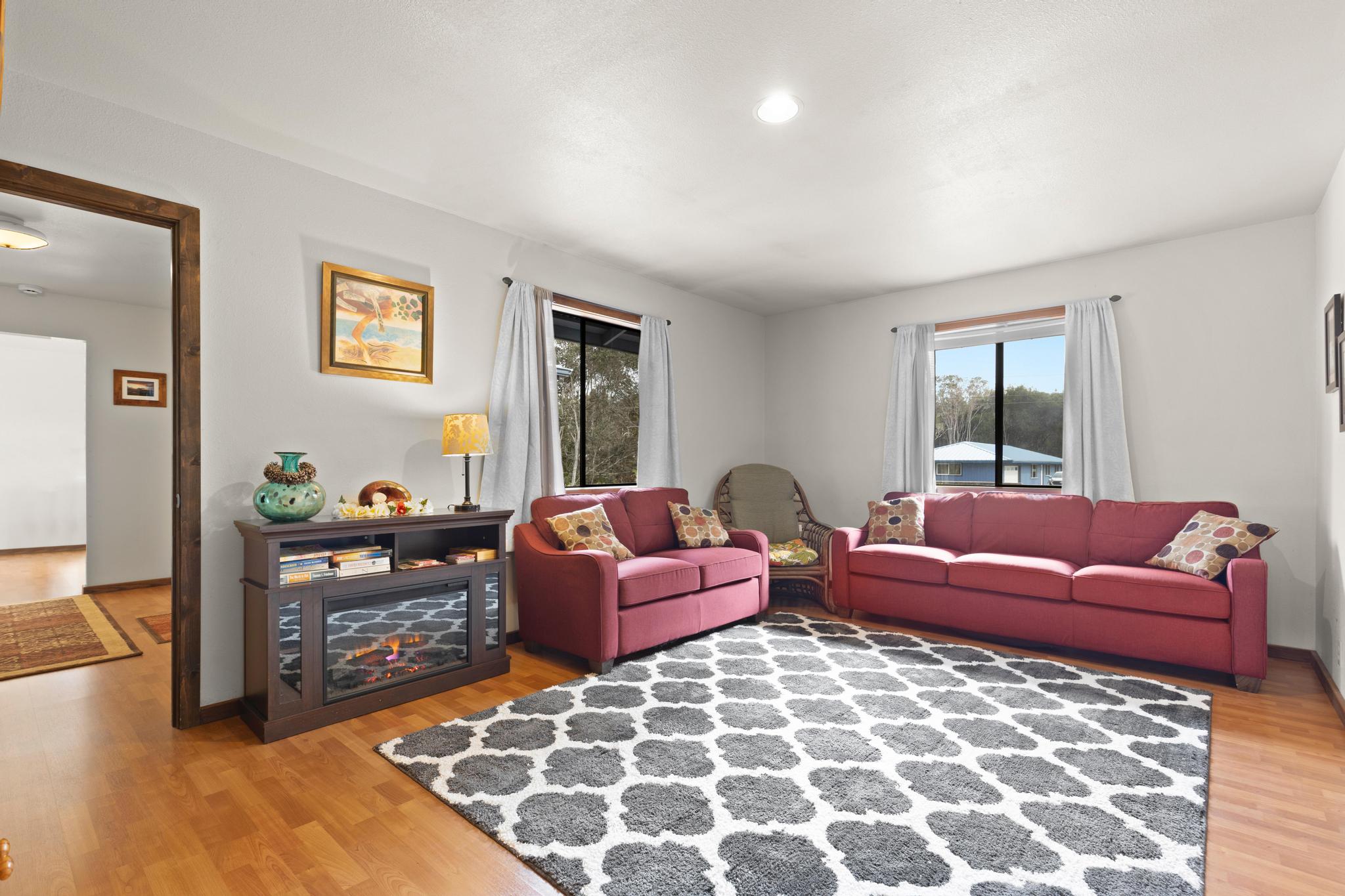 99-1817 Painiu Loop Volcano, HI 96785 - Photo 14 of 30 a living room with furniture and a flat screen tv
