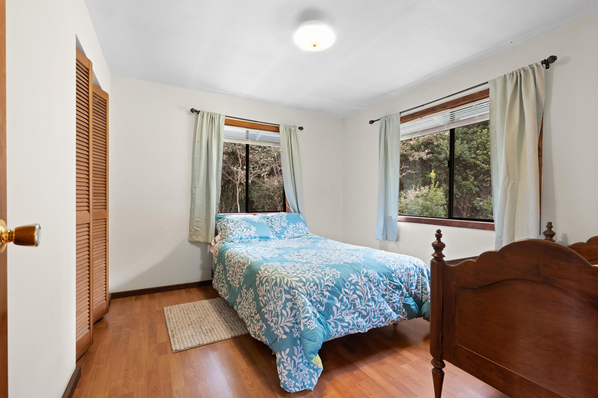99-1817 Painiu Loop Volcano, HI 96785 - Photo 17 of 30 a bedroom with a bed and a window