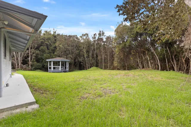 a view of a house with swimming pool and sitting area