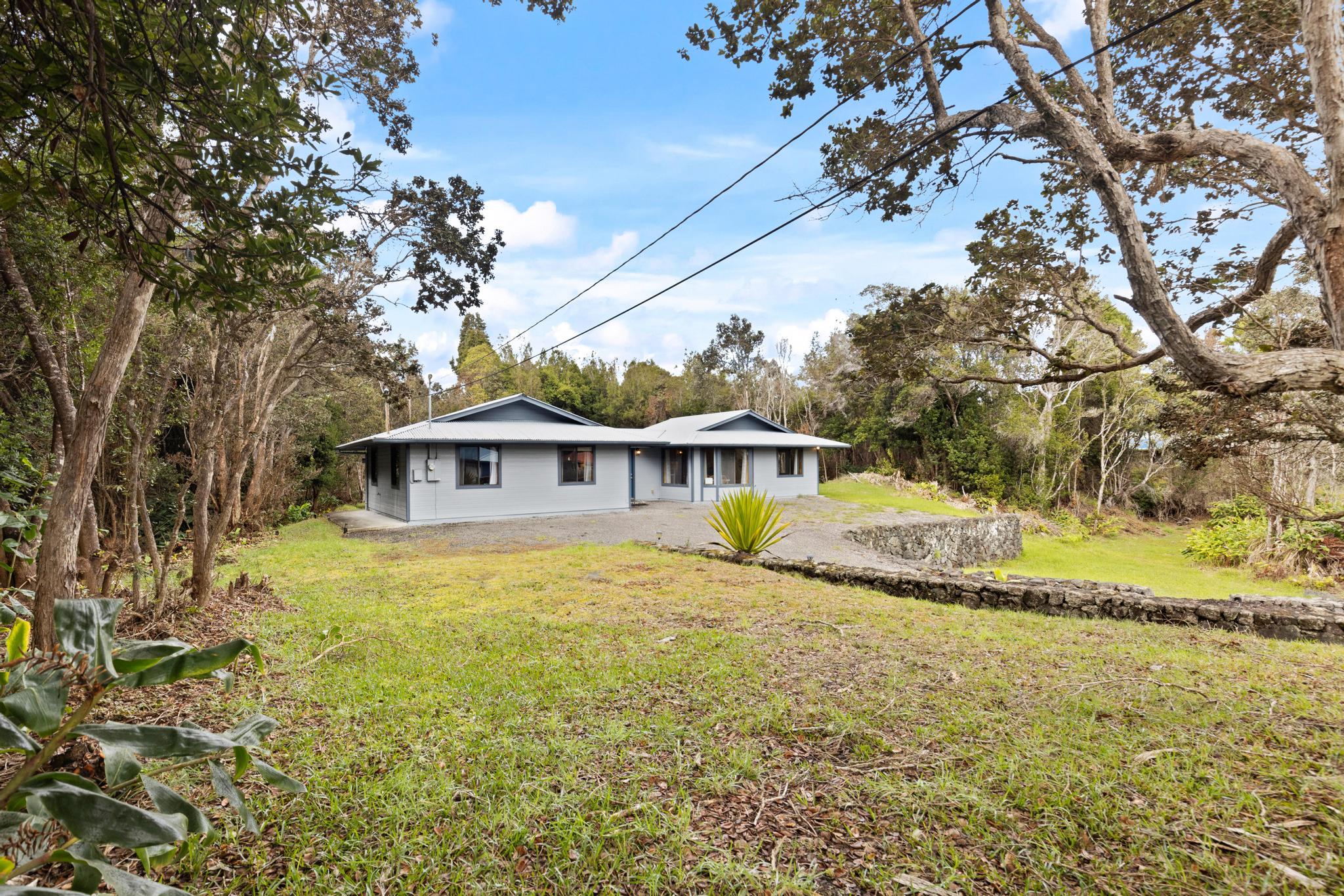 99-1817 Painiu Loop Volcano, HI 96785 - Photo 23 of 30 a view of a house with a yard