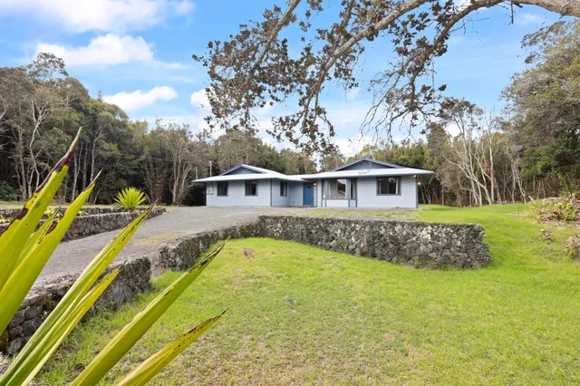 a view of a house with swimming pool and sitting area