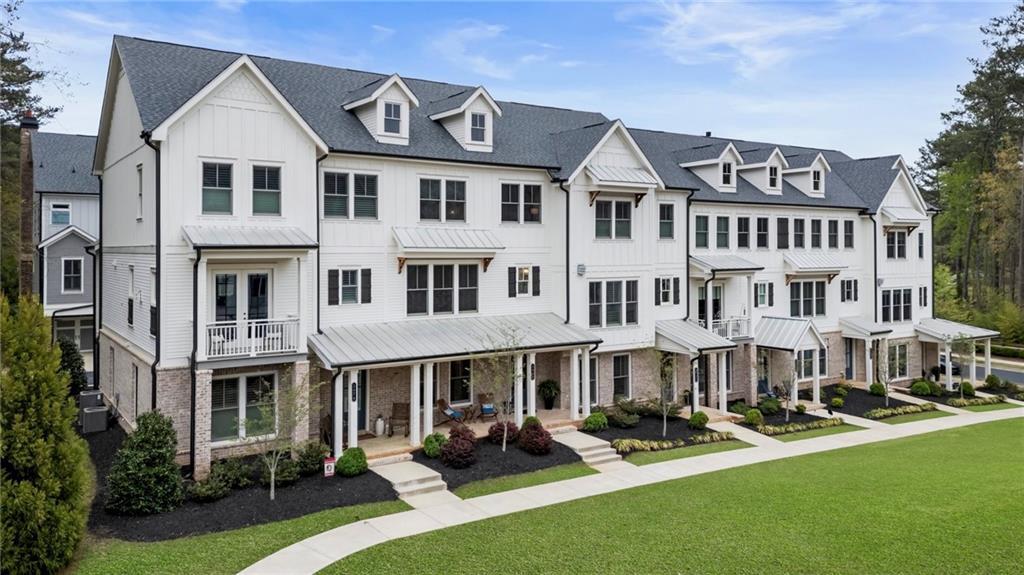 a view of an apartment with a garden and patio