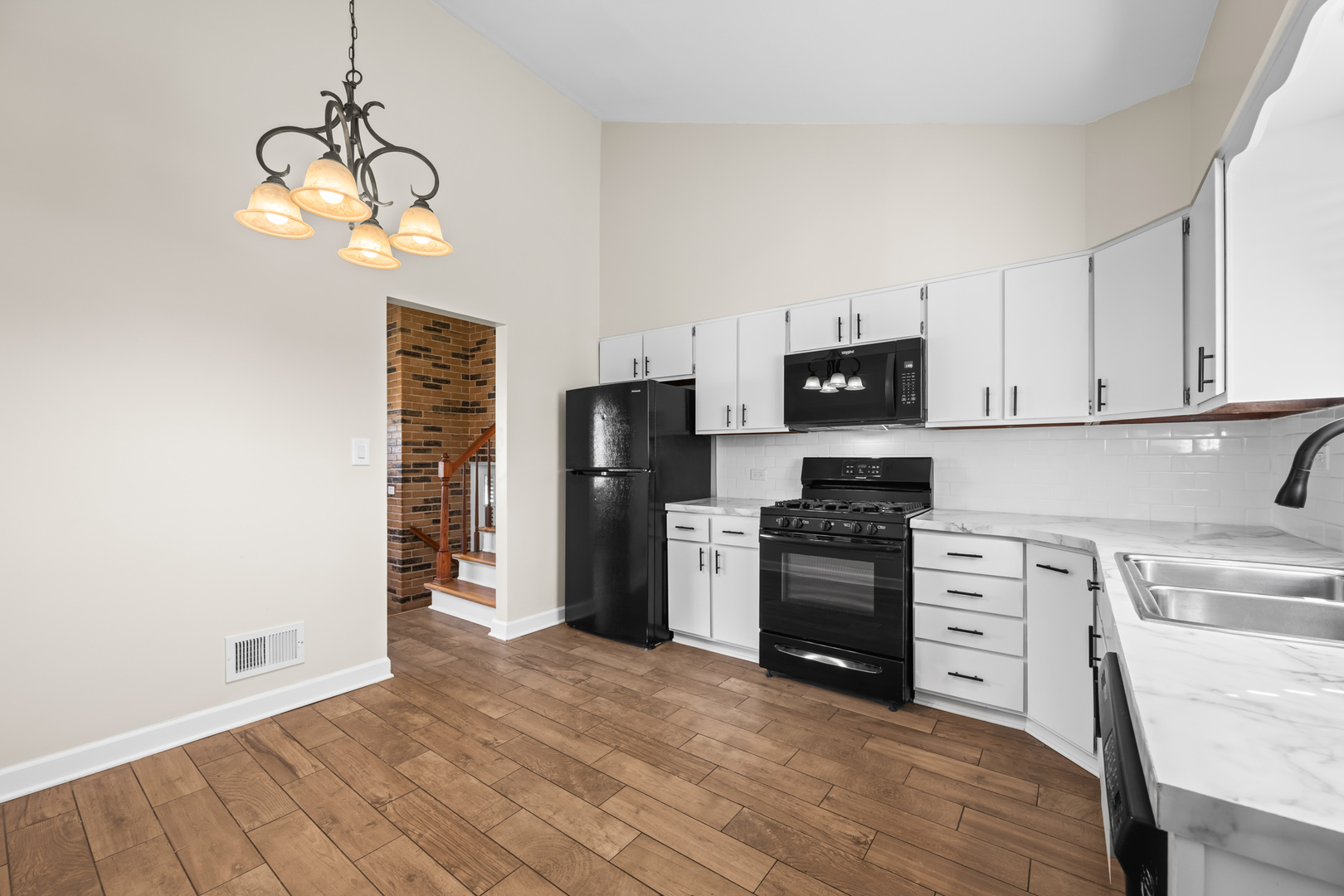 1917 Pawnee Lane Mount Prospect, IL 60056 - Photo 7 of 29 a kitchen with a refrigerator and a stove top oven