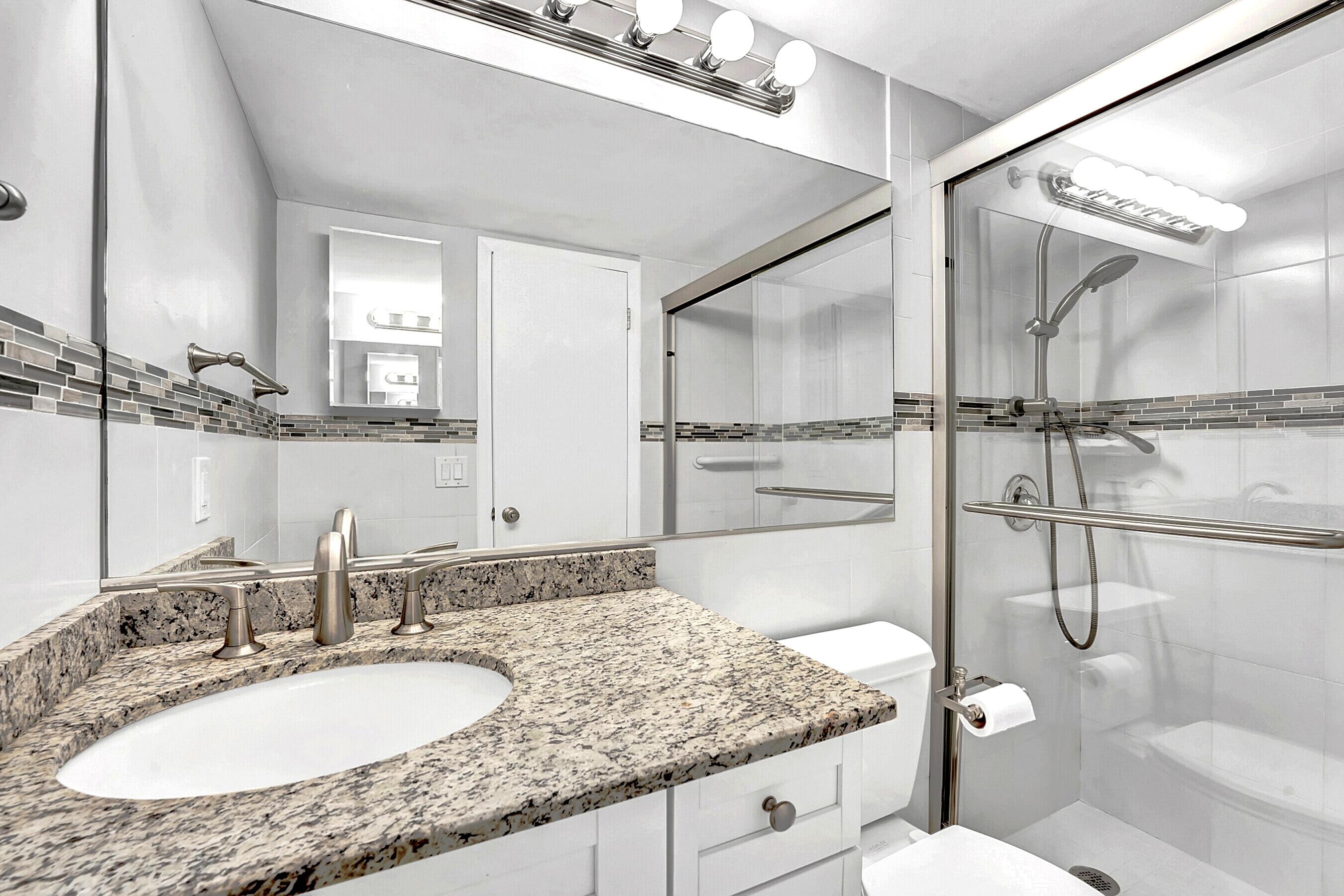 2046 Rexford Drive Boca Raton, FL 33434 - Photo 14 of 27 a bathroom with a granite countertop sink toilet and shower