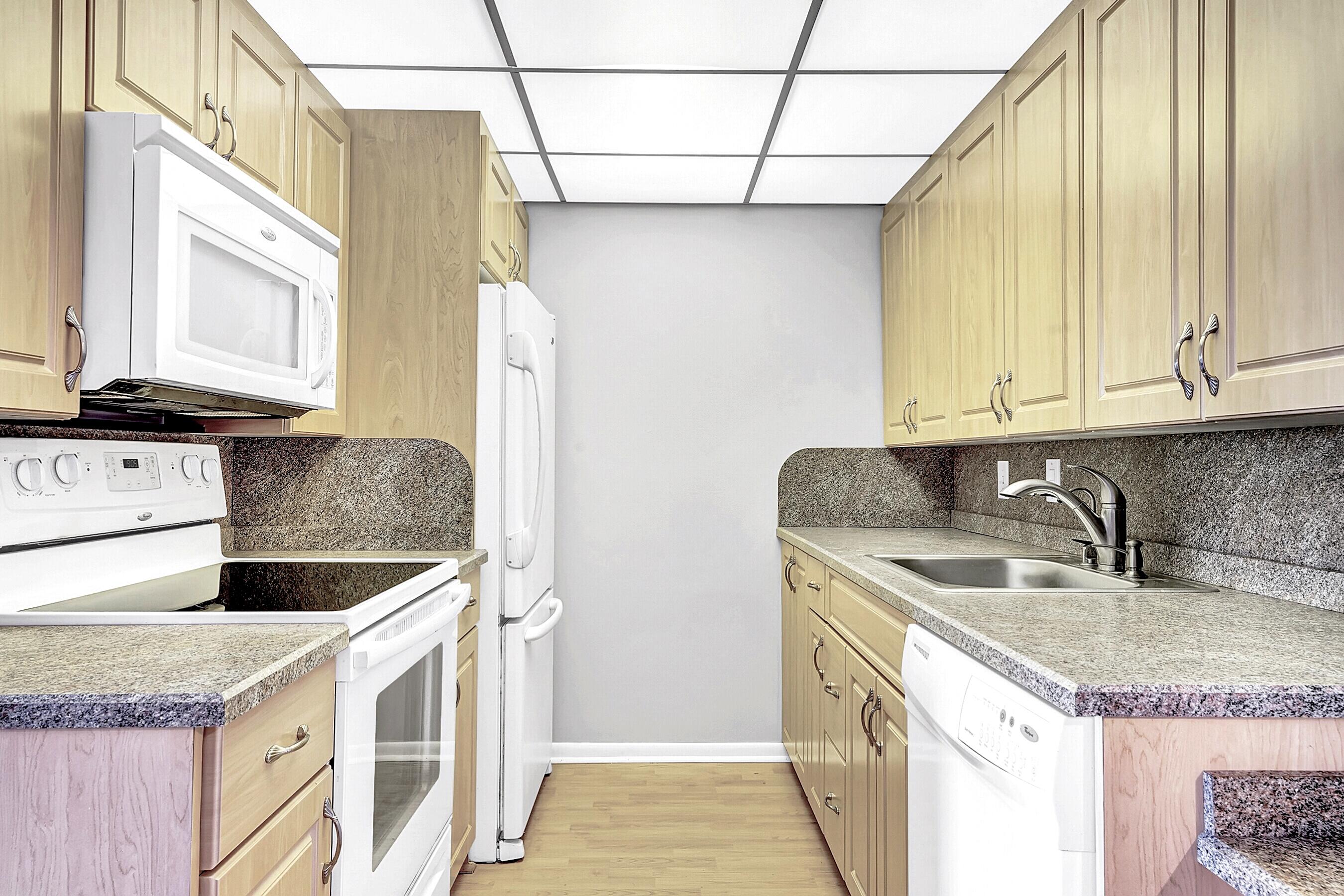 2046 Rexford Drive Boca Raton, FL 33434 - Photo 6 of 27 a kitchen with stainless steel appliances granite countertop a sink and dishwasher