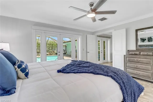 a spacious bedroom with a large bed and a chandelier