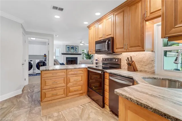 a kitchen with stainless steel appliances a stove sink microwave and cabinets