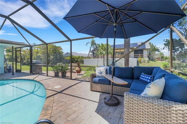 a view of a patio with couches and umbrella