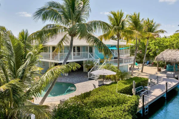 a view of a house with a yard patio and swimming pool