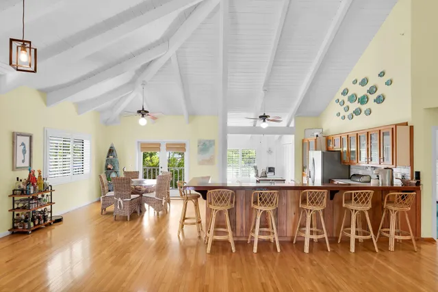 a view of a dining room with furniture large windows and wooden floor