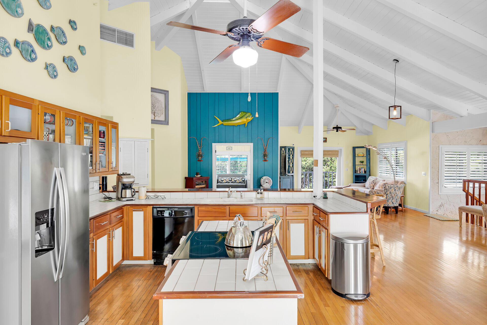 835 70th Street, Unit GULF Marathon, FL 33050 - Photo 17 of 46 a dining hall with stainless steel appliances granite countertop a stove a refrigerator a dining table and chairs with wooden floor