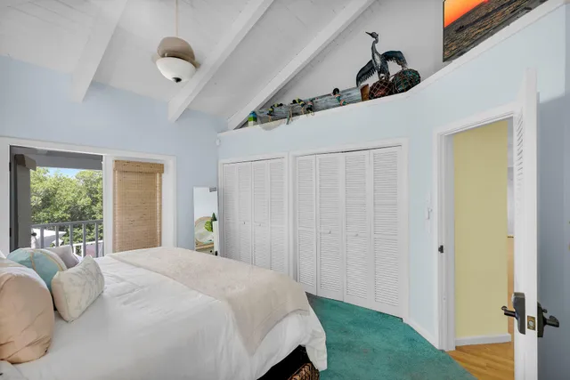 a bedroom with bed and a window