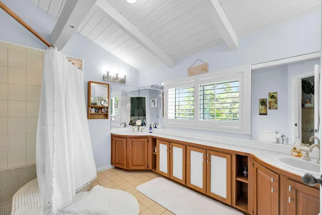 a bathroom with a tub sink and mirror