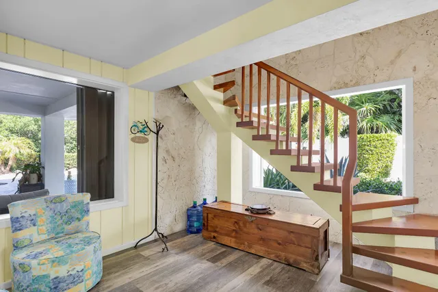 a front view of a house with a yard and potted plants