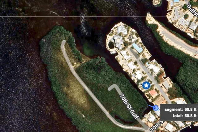 an aerial view of a house with a yard and garden