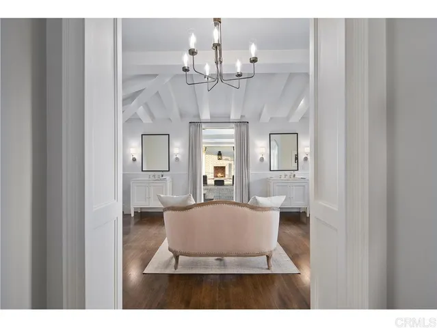 a view of a dining room with a chandelier and wooden floor