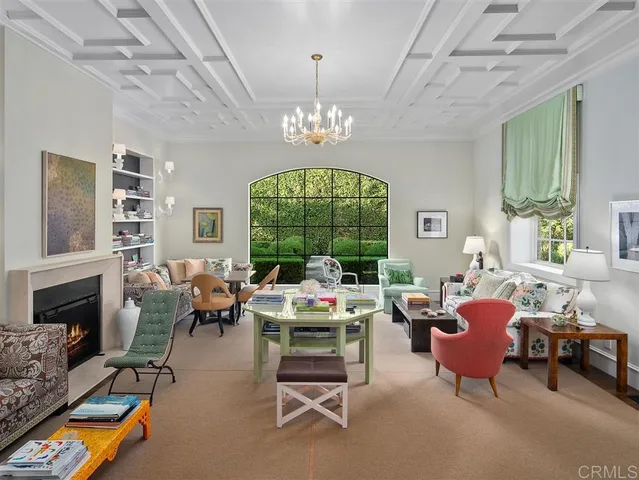 a living room with furniture fireplace and a chandelier