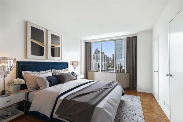 a bedroom with a large bed and a window