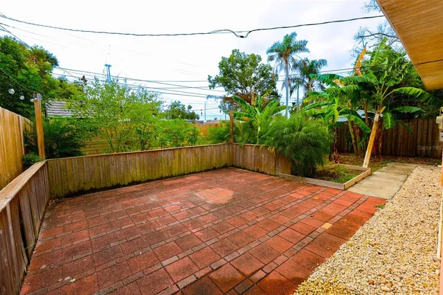 a view of a backyard with a tree