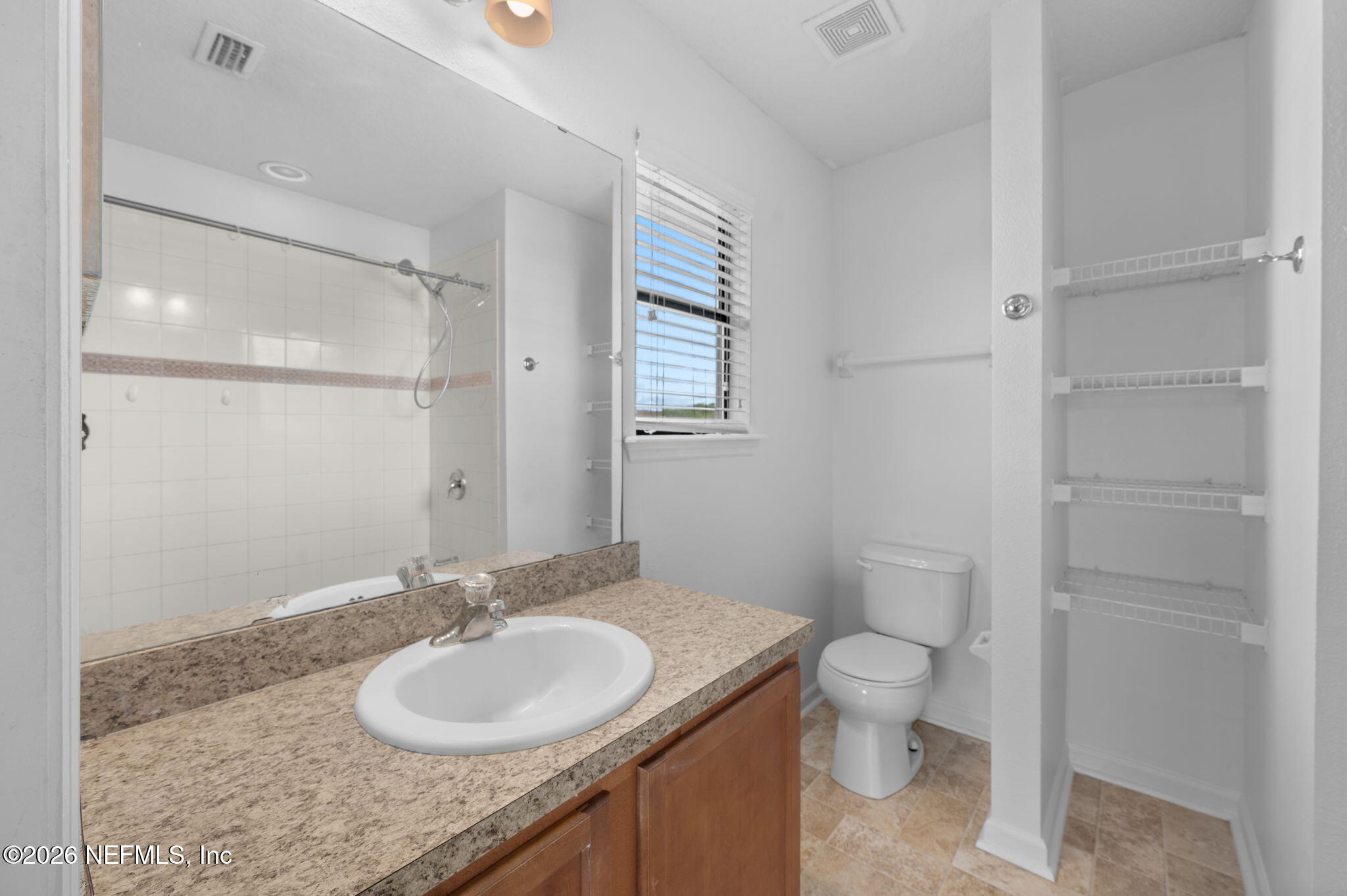 253 Syrah Way St. Augustine, FL 32084 - Photo 22 of 39 a bathroom with a granite countertop sink toilet and mirror