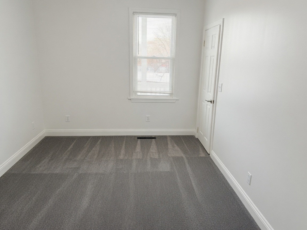 37 Madison Street, Unit 37 Malden, MA 02148 - Photo 6 of 10 an empty room with a window