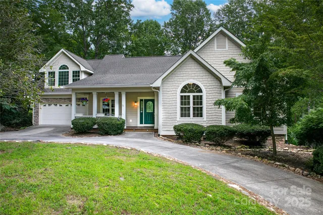 a front view of a house with a yard and outdoor seating