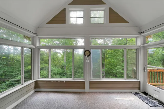 a view of empty room with floor to ceiling windows and floor to ceiling window