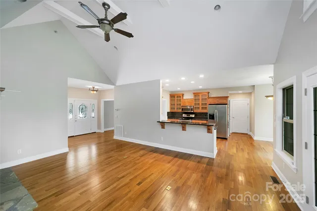 a view of a living room a window and wooden floor