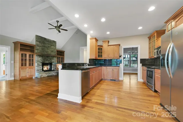 a large kitchen with cabinets and stainless steel appliances