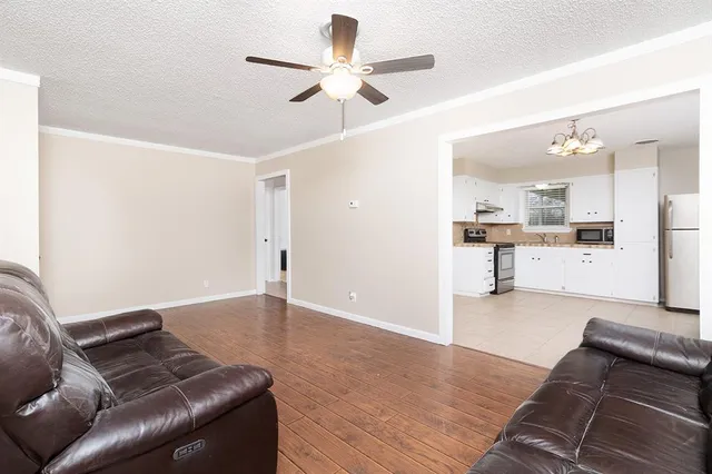 a living room with furniture and kitchen view