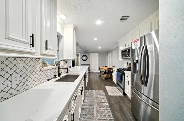 a kitchen with counter top space and stainless steel appliances