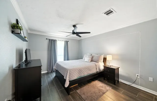 a bedroom with a bed and a chandelier