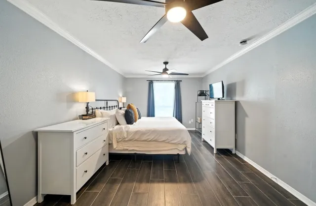 a spacious bedroom with a bed and a chandelier