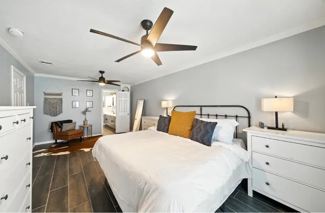 a bedroom with a bed and ceiling fan