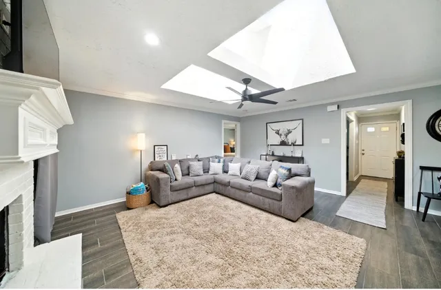 a living room with furniture and a wooden floor