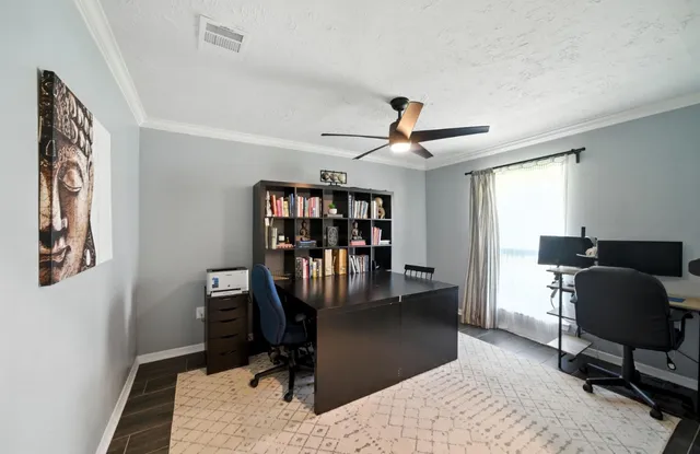 a view of a livingroom with workspace and a couch
