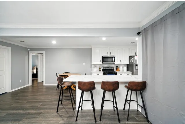 a view of a dining room with furniture and wooden floor