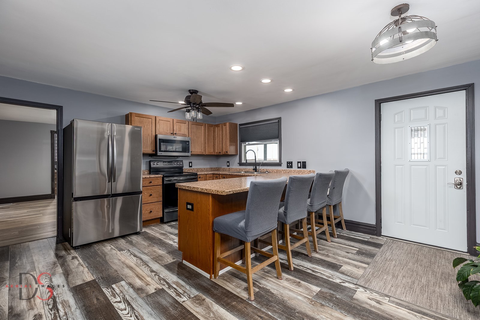 4775 West Dupont Road Morris, IL 60450 - Photo 11 of 24 a kitchen with stainless steel appliances granite countertop a refrigerator a stove a sink dishwasher and a dining table with wooden floor