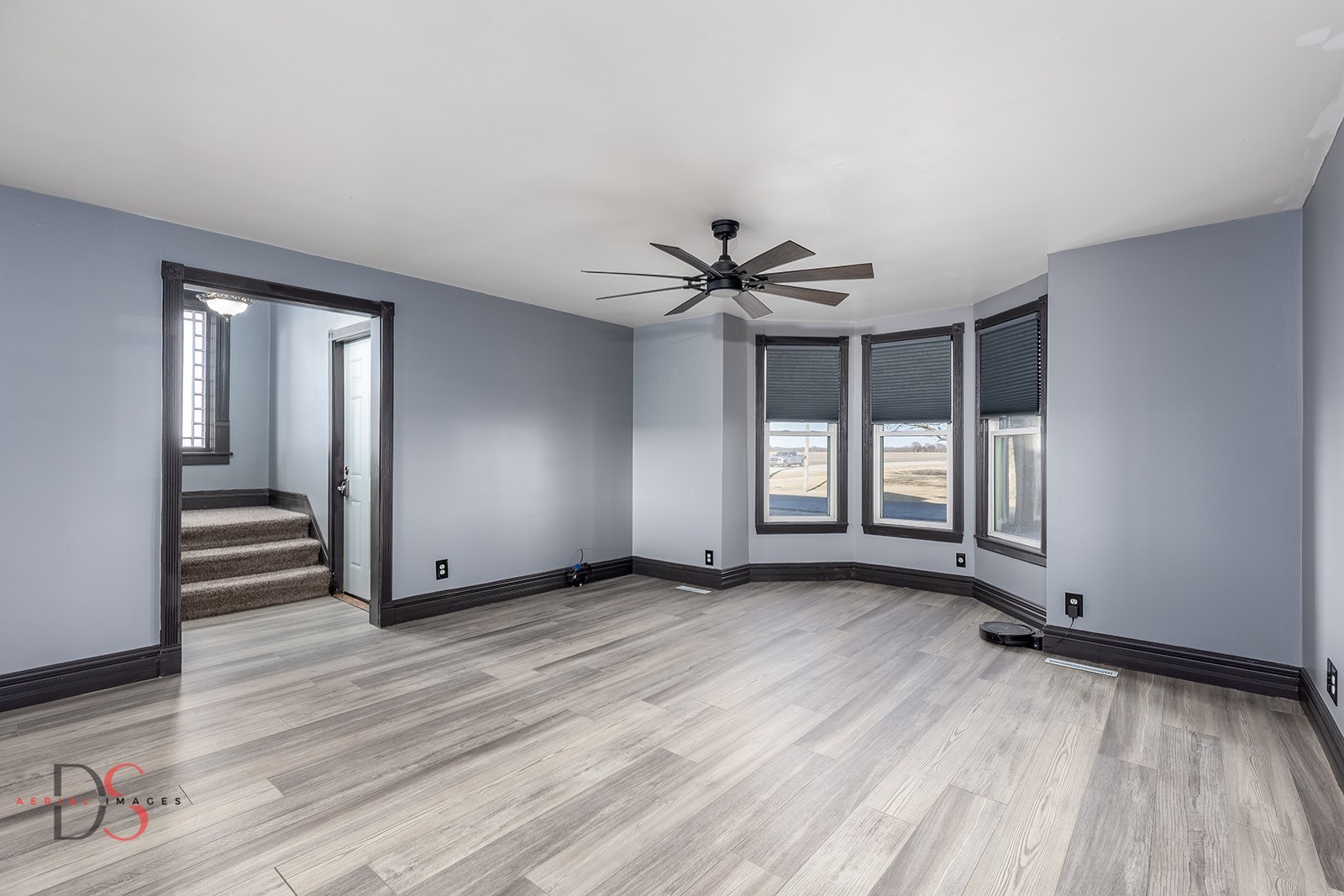 4775 West Dupont Road Morris, IL 60450 - Photo 16 of 24 a view of a livingroom with wooden floor and a ceiling fan
