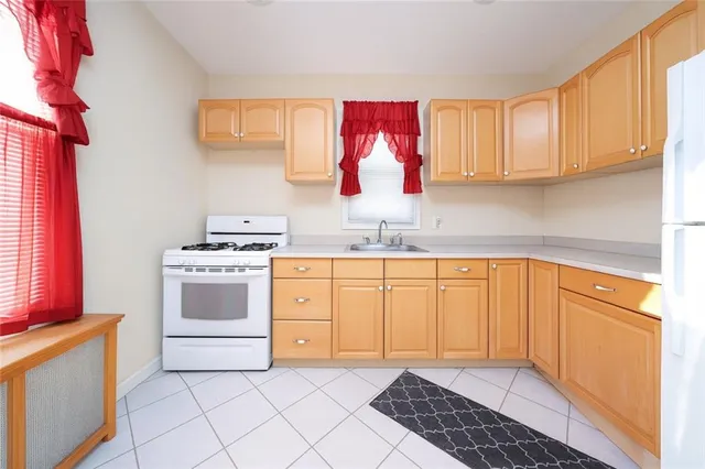a kitchen with a stove a sink and a refrigerator
